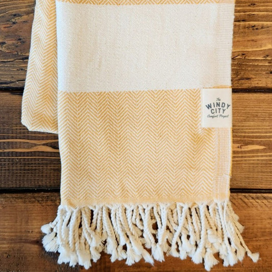 Summer Turkish Blanket - Mustard-Our popular Turkish Blankets are back and even better this year! Now crafted by a family business in Turkey from 100% OEKO-TEX certified organic cotton, and slightly bigger at 72" x 38", this Turkish Towel is ready for all your spring and summer activities! Perfect to use as a blanket, shawl, wrap, scarf, throw, tablecloth, picnic blanket, bath towel... the options are endless! The tightly weaved cotton makes them sand-repellent and quick drying - the ideal blanket to take t