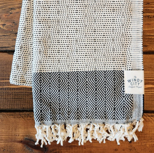 Summer Turkish Blanket - Black-Our popular Turkish Blankets are back and even better this year! Now crafted by a family business in Turkey from 100% OEKO-TEX certified organic cotton, and slightly bigger at 72" x 38", this Turkish Towel is ready for all your spring and summer activities! Perfect to use as a blanket, shawl, wrap, scarf, throw, tablecloth, picnic blanket, bath towel... the options are endless! The tightly weaved cotton makes them sand-repellent and quick drying - the ideal blanket to take to 