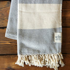Our popular Turkish Blankets are back and even better this year! Now crafted by a family business in Turkey from 100% OEKO-TEX certified organic cotton, and slightly bigger at 72" x 38", this Turkish Towel is ready for all your spring and summer activities! Perfect to use as a blanket, shawl, wrap, scarf, throw, tablecloth, picnic blanket, bath towel... the options are endless! The tightly weaved cotton makes them sand-repellent and quick drying