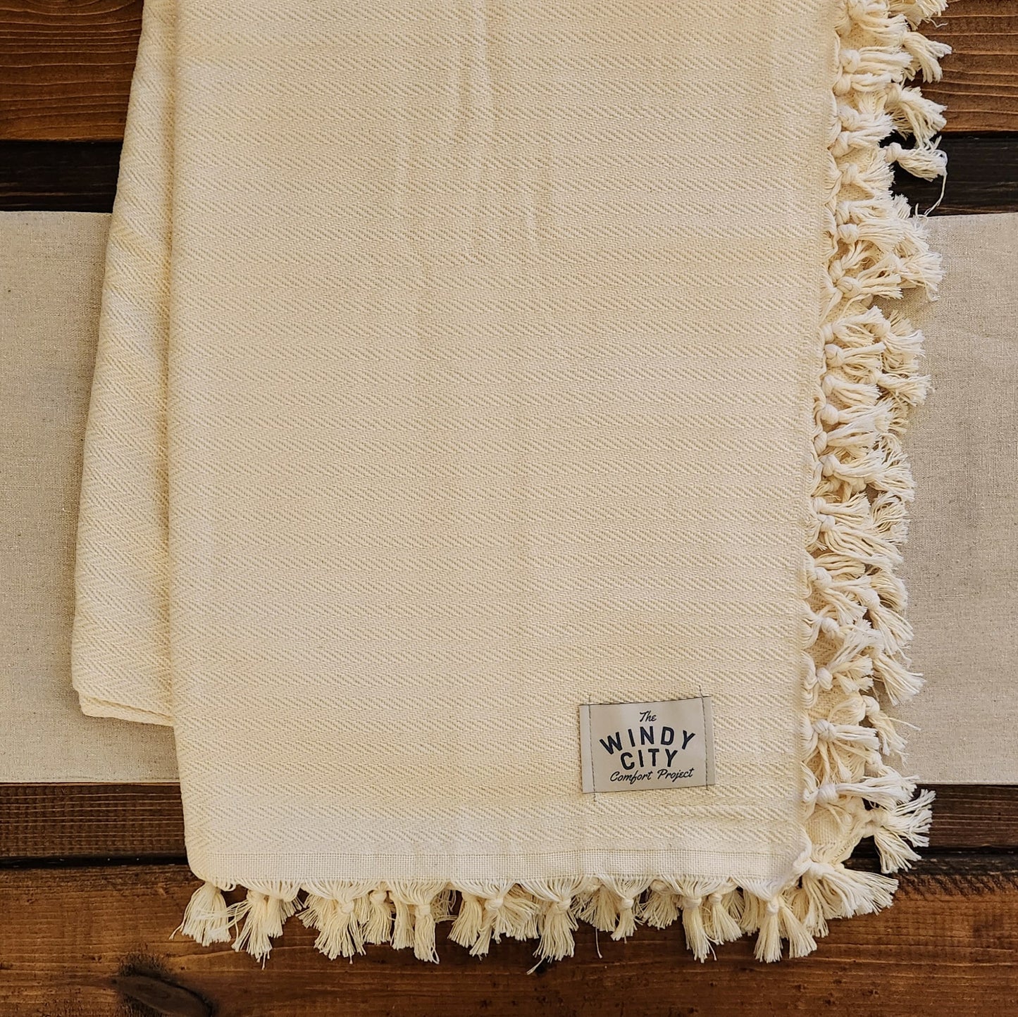 Our luxurious, solid cream-colored throw blanket brings a simple air of sophistication to any living space.